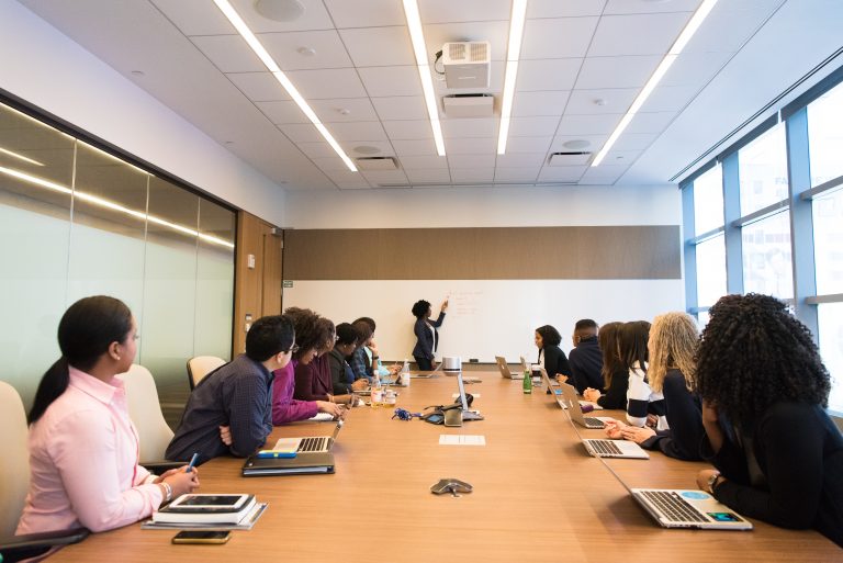 A room of board members deciding on the entity type and structure for their new subsidiary